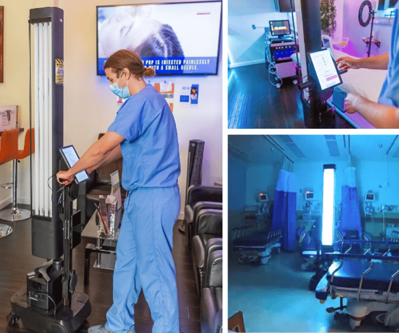 A healthcare worker uses the OhmniClean disinfection robot