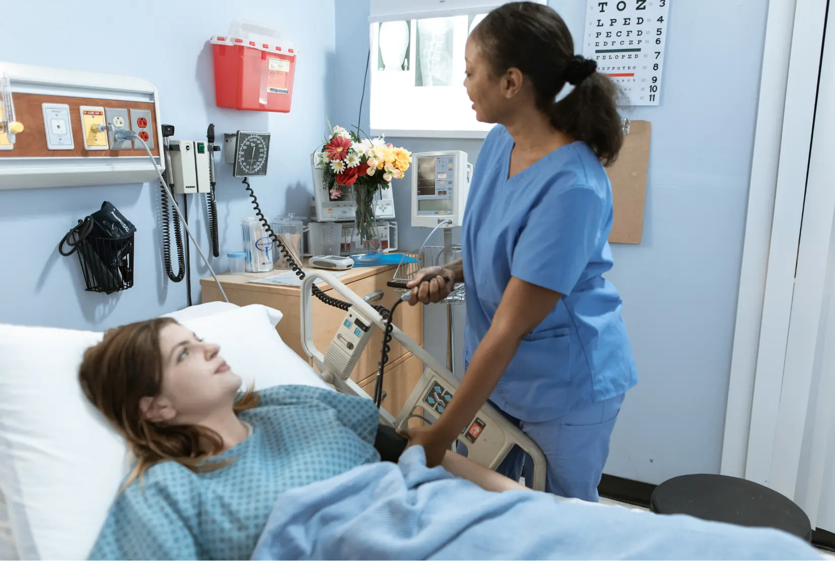 A nurse checking the vitals of a hospital patient