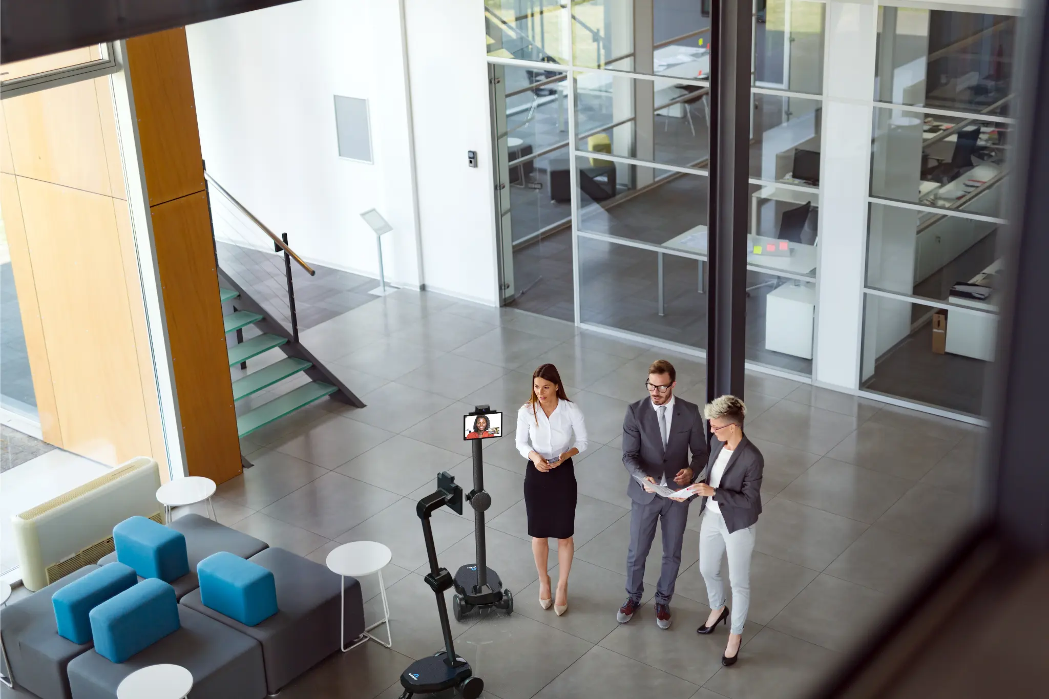 A group of employees meeting with a meeting robot